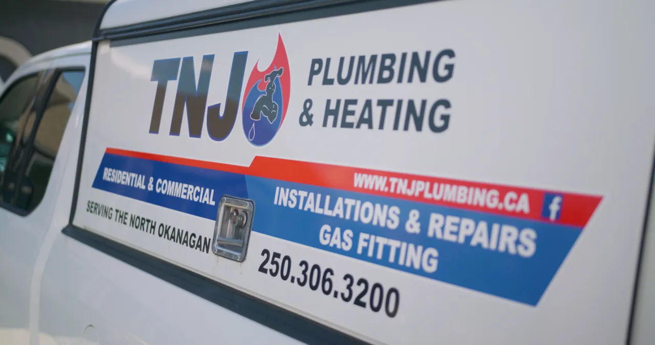 Woman dealing with water from burst pipe emergency